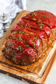 meatloaf with marinara sauce on a cutting board