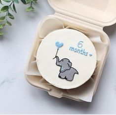 an elephant shaped cake in a box with the word 6 thronn on it