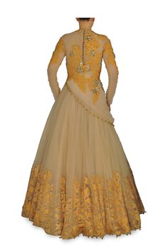 This indo western gown is made in fawn colour net. Embroidery on this indo western royal gown is in mustard yellow colour dori with diamond work. The hemline of this Indo Western gown also has applique work in velvet. This is royal looking piece and enhance the look of your wardrobe. Indo Western Outfits, Indo Western Gown, Western Gown, Net Embroidery, Western Outfits Men, Fawn Colour, Fab Dress, Applique Work, Beige Colour