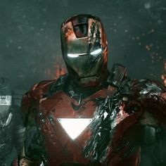 iron man standing in the dark with his hands on his hips