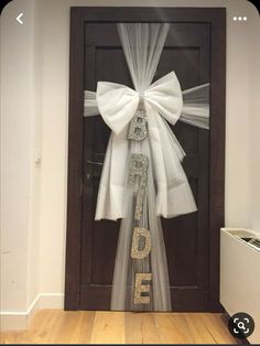 a door with a white bow and the word love on it