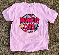 Get this popular new Wampus Cat colorful throwback shirt and show off your school spirit in style!  Each shirt is printed in-house by me using high-quality materials on a Comfort Colors shirt, known for its exceptional comfort, style, and durability. Available in unisex sizes S to 3X, and youth sizes, we've got you covered regardless of your preferred fit. The Wampus Cat paint splatter shirt features a classic crew neck and short sleeves, making it suitable for year-round wear. The flattering si Pink Tops For Streetwear With School Spirit, Pink Tops For School Spirit Streetwear, School Spirit Graphic Print Shirt For Streetwear, Pink Graphic Print Shirt For College, College Graphic Print Pink Shirt, College Shirt With Graphic Print In Pink, Wampus Cat, Paint Splatter Shirt, Summer Pink T-shirt With Cat Design