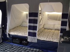 the inside of a camper with two beds in it