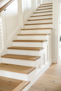 Explore chic modern farmhouse staircase designs that blend rustic and contemporary styles. This pin highlights whimsical wooden staircases and metal finishes that are perfect for enhancing your home's decor with inviting charm. Farmhouse Basement Stairs, Whitewash Staircase, Farmhouse Entryway With Stairs, Updated Staircase Ideas, Cottage Staircase Ideas, Shiplap Stairs, Modern Farmhouse Stairs, Attic Addition, Beach House Stairs