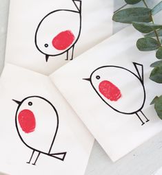 two cards with red birds drawn on them