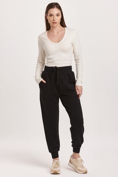 image of a female model wearing a DAHLIA HIGH RISE ANKLE JOGGER PANTS BLACK DEAR JOHN DENIM Black Athleisure Joggers With Side Pockets, Black Everyday Joggers With Pockets, Functional Black Joggers With Side Pockets, Functional Black Cotton Joggers, Black Ankle-length Joggers With Pockets, Tencel Denim, Denim Essentials, Dear John, Medium Wash Jeans