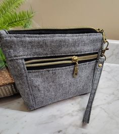 "These wristlets are the perfect size for carrying all of your essentials. The large zipper compartment is perfect for your wallet, phone or sunglasses with a smaller front zipper pocket that will hold other small valuables📱👓. These bags also feature waterproof canvas interior fabrics. They also have a gusseted bottom, which allows them to stand up on their own ✨ Product Details Handmade Measures approximately 8\"L x 5 1/2\"H x 1 1/2\"D 2 Zippers- 1 Main zipper compartment & 1 smaller front zi Wristlet Pouch, Monogram Towels, Black Wristlet, Passport Case, Cosmetics Bag, Monogram Tote, Wristlet Clutch, Interior Fabric, Zip Pouch