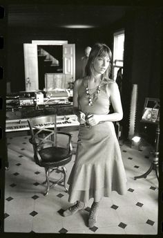 a woman standing in front of a piano