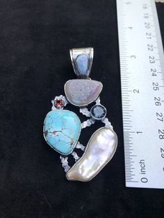 "Artisan Turquoise gemstone Pendant Hand-made Sterling Silver 925. Stones used: Rainbow Druzy, Turquoise, Australian Opal, Pearl, London Blue Topaz, Garnet Height - 3\" (with bail), Width - 1 5/8\" Height -75mm (with bail), Width - 40mm Unique Handcrafted One-of a-kind Design Each Piece of Jewelry in my Collection is Absolutely One of a Kind! When you start wearing a piece of my jewelry you will fall in love with it more and more each day and feel that good Energy and Love that I pass into it wh Elegant Turquoise Necklace For Gift, Turquoise Sterling Silver Pendant Gemstone, Turquoise Pendant Gemstone In Sterling Silver, Turquoise Pendant In Sterling Silver, Elegant Turquoise Natural Stone Beads, Artisan Jewelry With Stones For Wedding, Artisan Wedding Jewelry With Stones, Turquoise Natural Stones Pendant Gemstones, Turquoise Pendant Gemstone