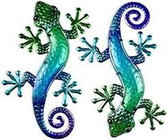 two green and blue geckos are standing next to each other on a white background