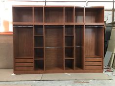 a large wooden bookcase with drawers in the middle of a warehouse flooring area