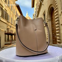 "This bag has been made of the best genuine leather by local master crafters of Florence in Italy, designed for women who only accept premium Italian quality and luxury leather bags and modern Italian fashion. . Size: Width: 27 cm / 10.75 inches Height: 19 cm / 7.50 inches Depth: 9 cm / 3.50 inches . The story of this bag : Once upon a time, in the charming city of Florence, Italy, renowned for its exquisite artistry and craftsmanship, there existed a small workshop tucked away in a cobblestone alley. This was the home of a gifted artisan named Alessio, whose passion for creating beauty out of leather was unparalleled. Alessio specialized in handcrafted leather goods, and his most prized creations were the leather clutch bags that exuded elegance and sophistication. The timeless charm of h High-end Everyday Bucket Shoulder Bag, Everyday High-end Bucket Shoulder Bag, High-end Everyday Leather Bucket Bag, High-end Brown Bucket Bag For Everyday Use, High-end Leather Bucket Bag, High-end Bucket Bag With Removable Pouch For Daily Use, High-end Daily Use Bucket Bag With Removable Pouch, High-end Leather Everyday Bucket Bag, High-end Leather Bucket Bag For Everyday