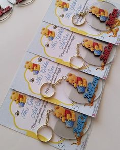 four winnie the pooh keychains are sitting on a table