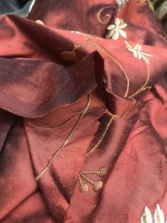 A beautiful Designer 100% Silk Taffeta in the most unique color of Rust Red. Floral embroidery cascades down the face of the fabric. Can be used for upholstery, interior decorating, or coat and skirts garments. Sold by the yard. 55” wide. Will combine shipping. Photo of the drapes are for inspirational purposes only, they are not made of the actual fabric but of similar fabric. The photos of the fabric is the actual fabric being sold. Check out more of our designer and runway fabrics by visiting Luxury Slub Silk Embroidered Fabric For Diwali, Luxury Silk Fabric With Resham Embroidery, Elegant Machine Embroidered Fabric For Festive Occasions, Festive Machine Embroidered Fabric For Parties, Elegant Embroidered Silk Fabric, Red Embroidered Fabric With Dupatta For Celebration, Festive Silk Embroidered Fabric For Celebration, Elegant Raw Silk Fabric For Festive Occasions, Elegant Red Fabric For Festive Occasions