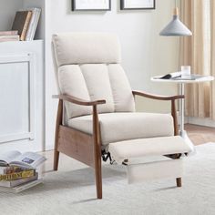 a living room with a chair, table and pictures on the wall