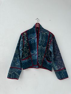 a blue jacket hanging on a white wall