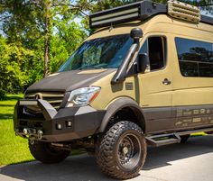 an off - road vehicle is parked in the driveway