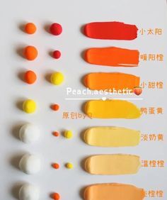 an assortment of different colors of paint on a white surface with chinese characters in the background