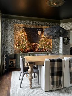 the dining room is decorated for christmas with plaid chairs and an old - fashioned chandelier