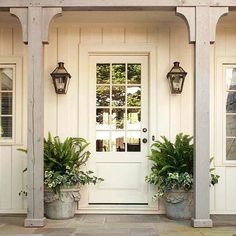 a white door with two planters on the side and an advertise for re - deck