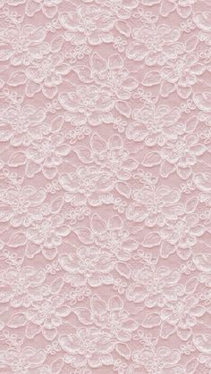 a pink wallpaper with white lace on the top and bottom half, in an ornate pattern