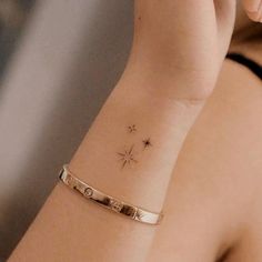 a woman's arm with a star tattoo on it