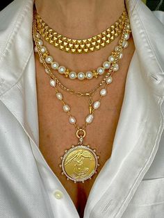 This feminine but wildly striking coin pendant is our newest edition to our popular coin collection. Large Brushed gold Winged Victoria Coin set in a crystal and pearl bezel with white freshwater pearl 14k gold chain. Measures 21” long and we added some chain you can adjust the length to wear shorter, lobster clasp closure. Coin is a reproduction, measures 50mm total, and is brass with gold plate. All materials are free from cadmium, lead, and nickel. Three Piece Set includes Winged Victoria nec Inexpensive Jewelry, Looks Street Style, Gold Necklace Women, Gold Necklace Designs, Coin Jewelry, Custom Jewelry Design, Coin Necklace, Stunning Jewellery, Coin Pendant