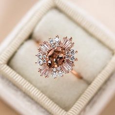 an engagement ring in a box with diamonds on the inside and around it's center