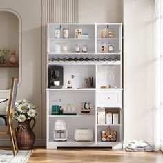 a dining room table and chairs in front of a white bookcase