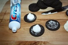 an oreo cookie with toothpaste on it next to other cookies and a tube of tooth paste