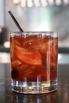 a close up of a drink in a glass on a table