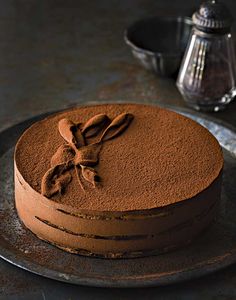 a chocolate cake is sitting on a plate