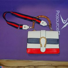 White Handbag With Navy & Red Stripes On Front, Faux Bamboo Style Handle, Navy & Red Strap Attached As Well.... Strap Can Be Taken Off And Adjusted To Be A Little Longer, One Little Mark On Back Of Bag That I Pointed At But It's Barely Noticeable, Inside In Great Condition As Well, Only Used Once So Almost Like New, No Name Brand, 9 Inches Across, 6 Inches Top To Bottom, A Little Over 1 Inch Wide But That's With Nothing Inside, It Has 2 Sections And 2 Pockets Inside, Any Questions Ask Red Rectangular Bag With Strap, Rectangular Red Bag With Strap, Red Rectangular Shoulder Bag With Strap, Red Crossbody Bag With Strap, Trendy Red Shoulder Bag With Branded Hardware, Trendy Red Bag With Strap, Trendy Red Shoulder Bag With Strap, Trendy Red Bag With Branded Hardware, Trendy Red Bags With Branded Hardware