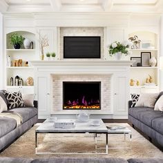 a living room with two couches and a fire place in the middle of it