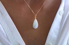 This stunning necklace features a genuine Moonstone Teardrop wire wrapped to perfection and sets on a dainty 18k gold-filled chain.  This beautiful piece makes a special gift!  G E M S T O N E  *  Genuine Moonstone with color flashes in the light and movement.  *  Stone size is approximately 23 mm in length  * Due to the one-of-a-kind nature of the stones, they may vary slightly in color, hue, and reflection  C H A I N   Fine finish 18k gold filled chain box (0.5 mm)  18k gold-filled jewelry is created with a thick layer of 18k solid gold over a metal core. Gold-filled jewelry is a beautiful, affordable alternative to solid gold, and it is an excellent option for long-lasting pieces.  C H A I N  L E N G T H  Choose your favorite chain length and rock it! Available in 16, 18, and 20 inches White 14k Gold Filled Teardrop Necklace, Elegant Wire Wrapped Drop Necklace For Gift, Elegant Hand-wrapped Moonstone Jewelry, Elegant Hand Wrapped Moonstone Jewelry, Elegant White Hand Wrapped Necklace, Elegant White Hand-wrapped Necklace, Elegant Hand Wrapped Moonstone Necklaces, Elegant Opal Necklace With Wire Wrapped Detail, White Wire Wrapped Drop Jewelry