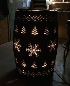 a lit up vase sitting on top of a table next to a bar stool in a room