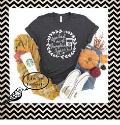 a black shirt with white writing on it next to some fall leaves and pumpkins