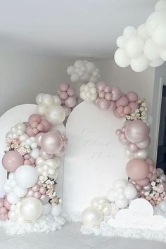 an arch made out of balloons and flowers