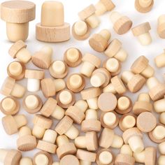 wooden pegs are scattered on top of each other, including one that has been cut into smaller pieces