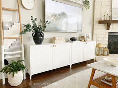 a living room filled with furniture and a large tv mounted to the side of a wall