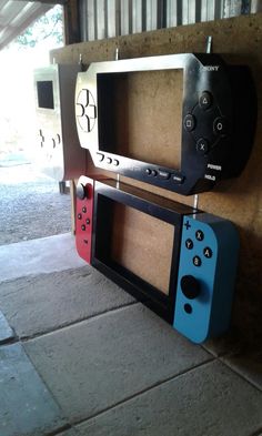 two nintendo wii game controllers sitting on top of each other next to a brick wall