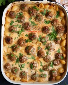 a casserole dish filled with meatballs and pasta in a creamy sauce, garnished with parsley