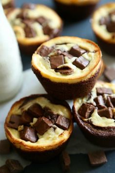 chocolate and marshmallow cupcakes are stacked on top of each other with milk in the background