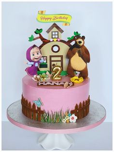 a birthday cake with masha and the bear on top is decorated in pink frosting