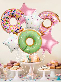 an assortment of doughnuts and balloons on a table