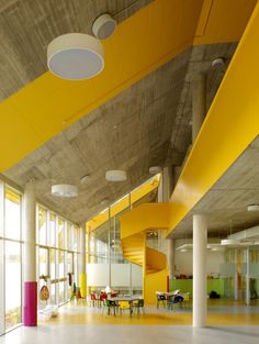 the interior of an office building with yellow and orange colors on the walls, floors and ceiling