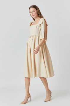 This linen midi dress is sweet as a summer breeze. Its shoulder bow tie adds a playful twist while a square neckline and back smocking detail give it a vintage vibe perfect for sunny days. In a midi length it's modest yet flirty pair it with espadrilles for a casual brunch or dress it up with wedges for an evening stroll. Whether you're sipping sangria in Barcelona or touring Tuscany's countryside this dress will keep you looking chic and feeling cool as temperatures rise. Best of all linen fabr Linen Midi Dress, Summer Breeze, Vintage Vibe, Casual Style Outfits, Style Outfits, Vintage Vibes, Full Skirt, Square Neckline, Linen Fabric