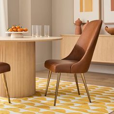 a dining room table with two chairs and a vase on the table in front of it