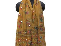 Pattern - embroidered sequin scarf. Ideal for - women/ girls. Occasion - formal or casual. Fabric - cotton. It has an embroidered floral pattern all over. This piece is from the Kutchh area of Gujarat. It is hand-painted and embroidered. Color - On a light yellow background, embroidery is done with different colored threads and mirror sequins. Plastic sequins are used because they are lightweight. Size - 40 x 84 inches(approx). Care - gentle hand wash. For more such scarves please visit- https:/ Traditional Dupatta With Mirror Work For Spring, Bohemian Scarves With Multicolor Embroidery, Traditional Spring Scarves As Gifts, Traditional Spring Scarves For Gifts, Traditional Cotton Shawl For Spring, Traditional Spring Scarves For Gift, Festival Scarves With Motifs, Embroidered Beige Cotton Dupatta, Beige Embroidered Cotton Dupatta