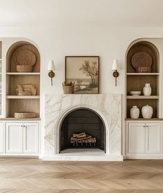 a living room filled with furniture and a fire place in front of a white fireplace